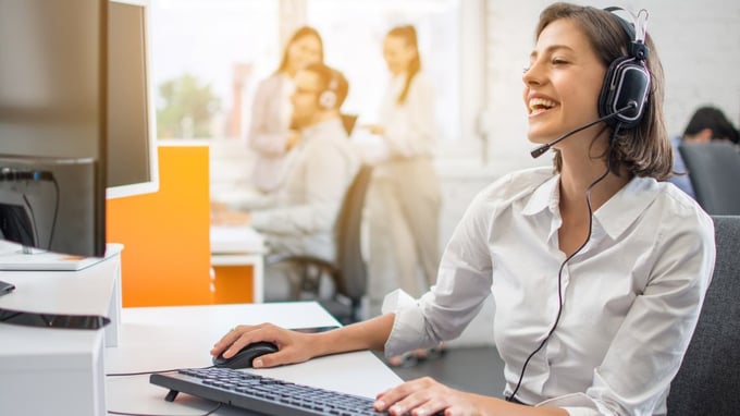 IT technician smiling during remote customer service.